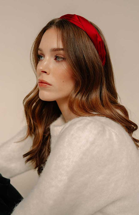 Pleated red silk headband styling a holiday outfit