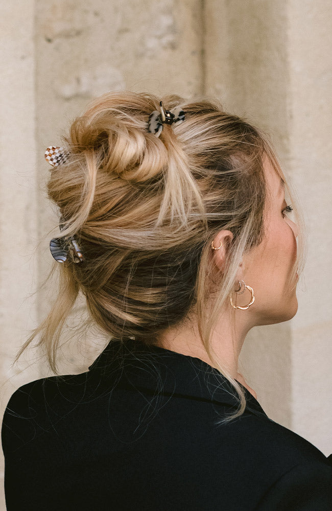 France Luxe Grey Mini Claw Hair Clip holding straight, blonde hair back in a loose bun.