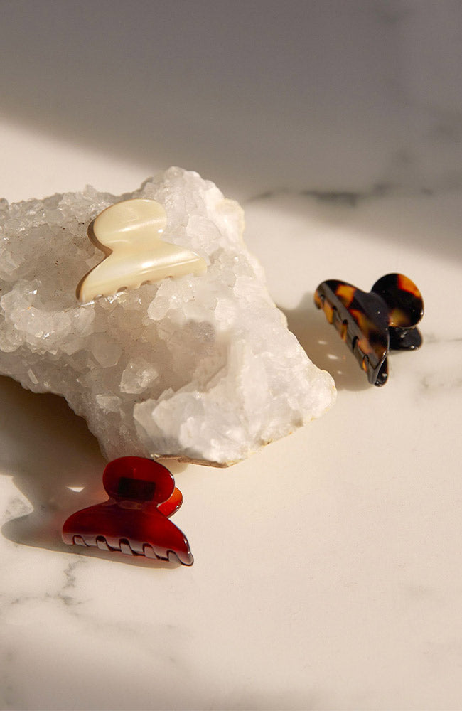 Several elegant Mini Couture French Hair Clips by France Luxe pictured on crystal.