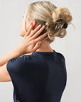 Woman with straight, blonde hair styled in a twist updo with a France Luxe small, Grey claw hair clip.