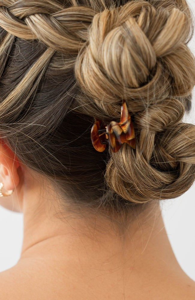 Woman with straight, blonde hair styled in a braided updo with a France Luxe mini, Brown claw hair clip.