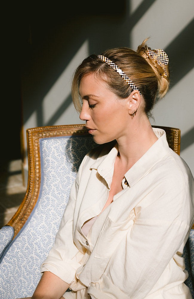 Woman with straight, blonde hair styled in an updo with a France Luxe small claw hair clip, checkered tortoise and ivory.