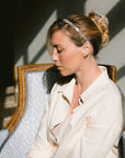 Woman with straight, blonde hair styled in an updo with a France Luxe small claw hair clip, checkered tortoise and ivory.