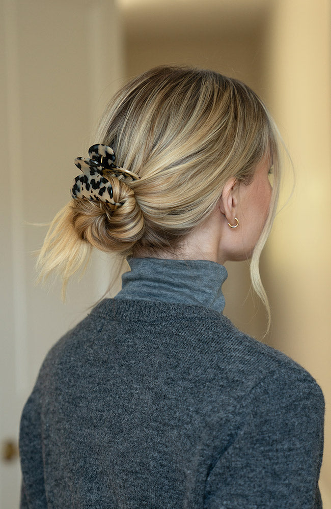 Woman with straight, blonde hair styled in a low bun with a France Luxe small, Ivory Tortoiseshell claw hair clip.