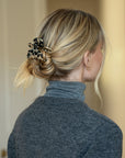 Woman with straight, blonde hair styled in a low bun with a France Luxe small, Ivory Tortoiseshell claw hair clip.