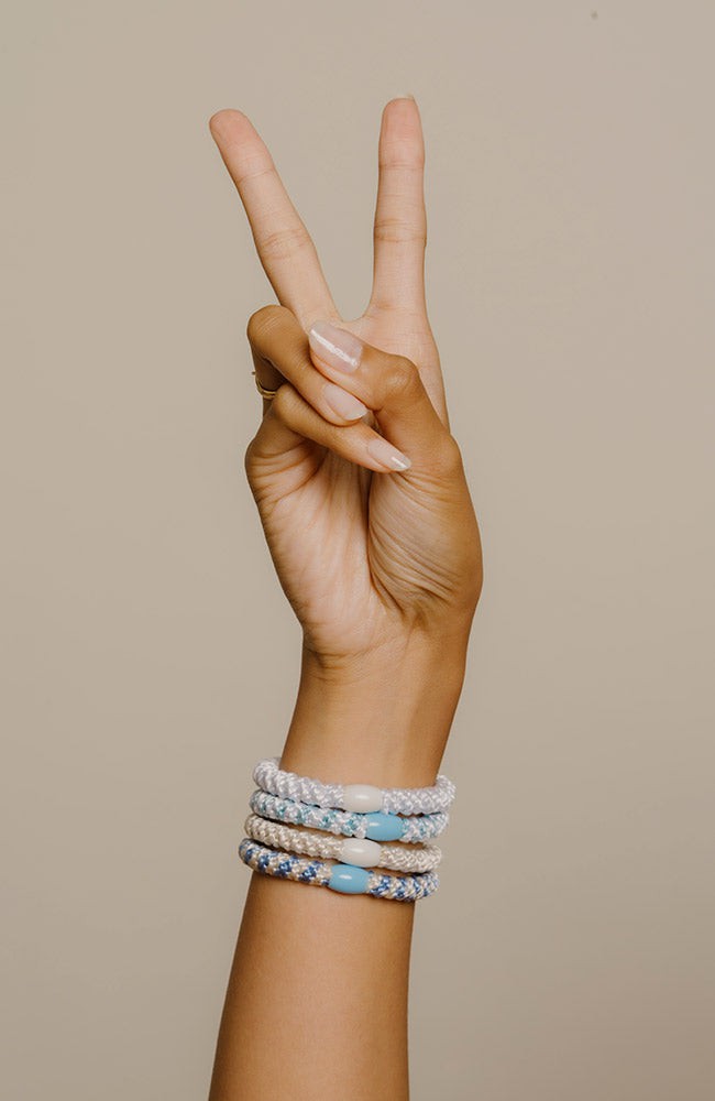 Blue hair ties for thick hair, hair tie bracelets on wrist. Quality ponytail holders by L. Erickson.