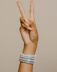 Blue hair ties for thick hair, hair tie bracelets on wrist. Quality ponytail holders by L. Erickson.