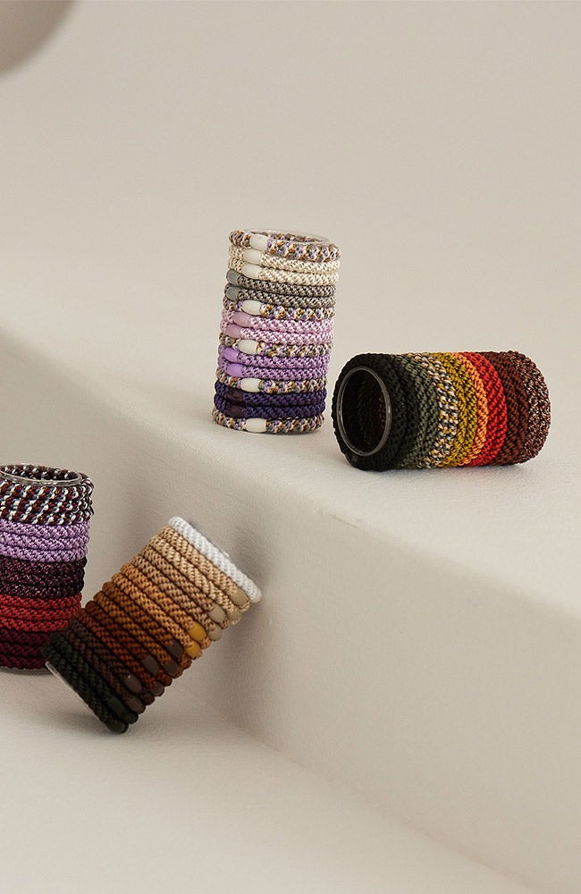 L. Erickson thick hair tie tube packs. Strong, no-damage ponytail holders in brown packs.