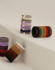 L. Erickson thick hair tie tube packs. Strong, no-damage ponytail holders in brown packs.