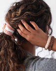 Pink hair ties for thick hair, seen on woman with voluminous, curly  hair. Extra thick fuzzy ponytail holder by L. Erickson.