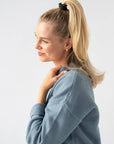 Black hair ties styling a straight half up, high ponytail. L. Erickson Grab & Go Pony, Black Opal.