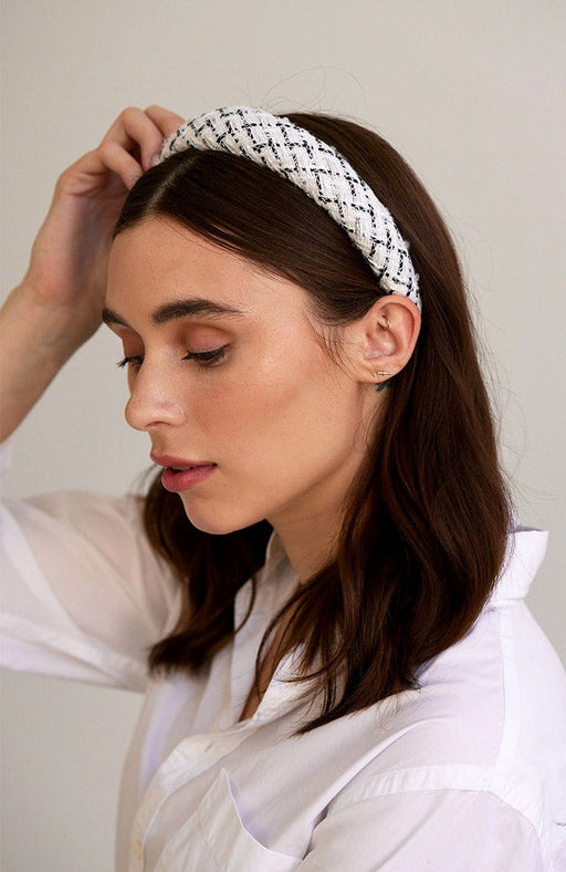 Black and white weave fabric on a padded headband, pictured in medium length, brown straight hair.