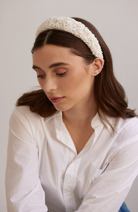 White beaded headband by L. Erickson, pictured on a women with brown hair