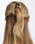 Long blonde hair in bun twist with hair pin