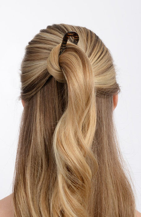 Long blonde hair in bun twist with hair pin