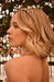 stunning crystal headband by L. Erickson, pictured on a bride with blonde hair styled with loose flowing wave.