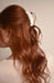 Woman with red hair has her hair held back with Alba Couture Jaw by France Luxe